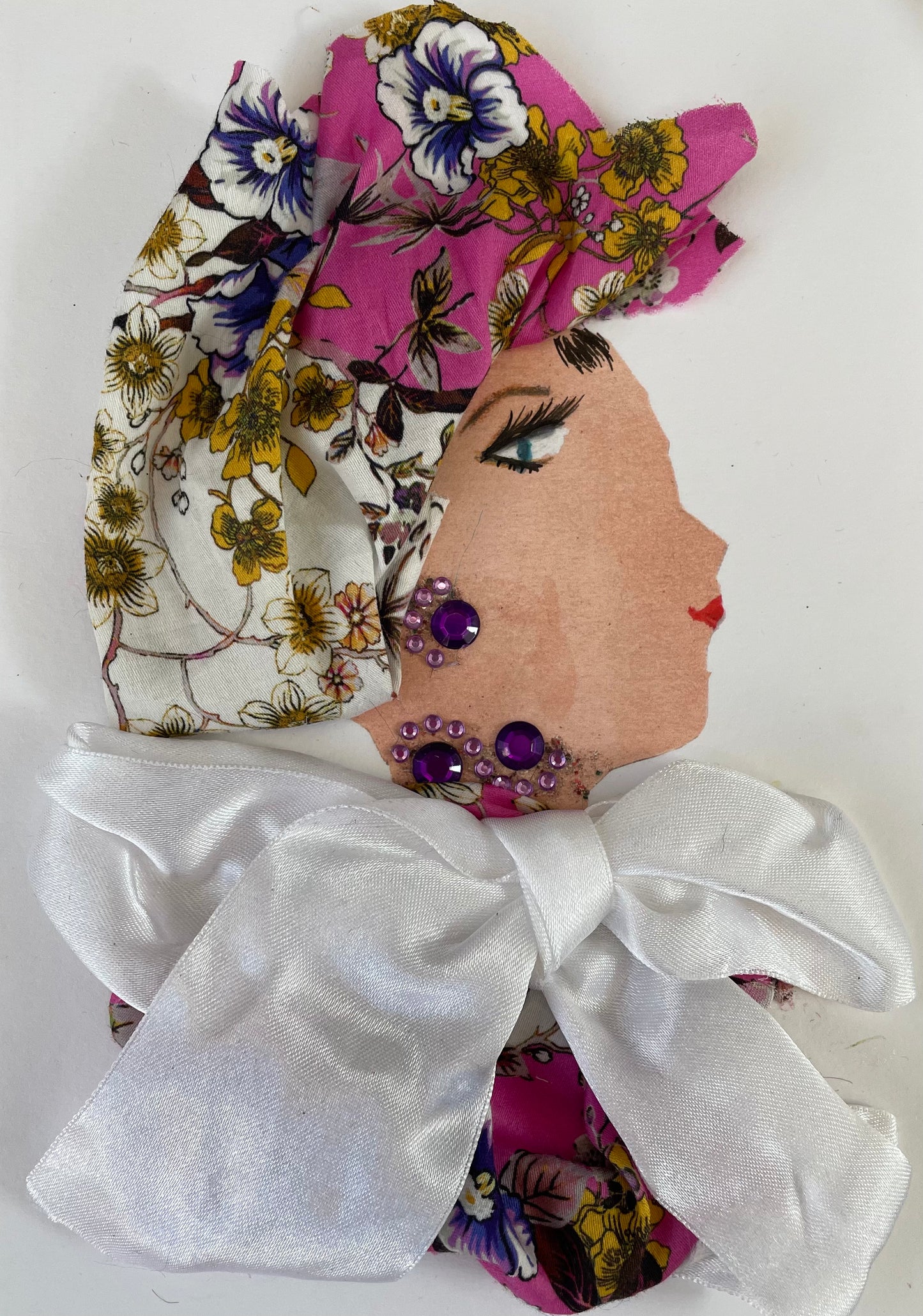 I have called this card Willa Woolwich she is wearing a pink, white, yellow and purple floral printed blouse with a matching head wrap. She has a big white bow on top of her blouse. She compliments her outfit with purple jewel-like earrings and necklace. Do you know any wonderful woman with a birthday today ?