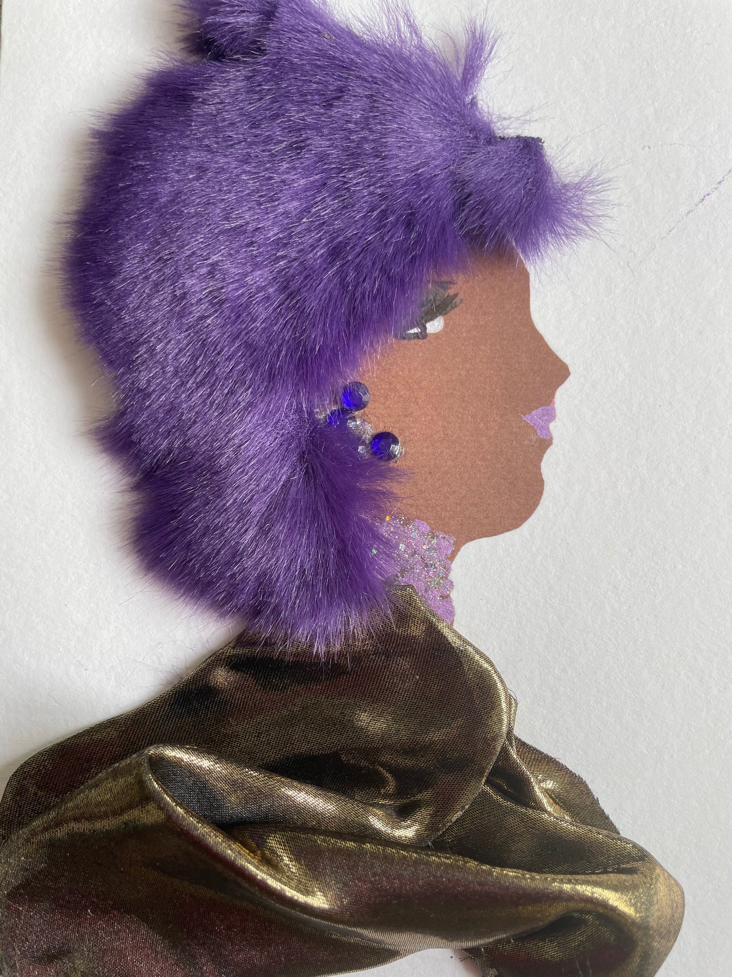 I designed this card of a woman named Goodmayes Gamma. She has soft, fluffy purple hair. She wears a beautiful, reflective gold dress and has purple jewellery to match her hair.