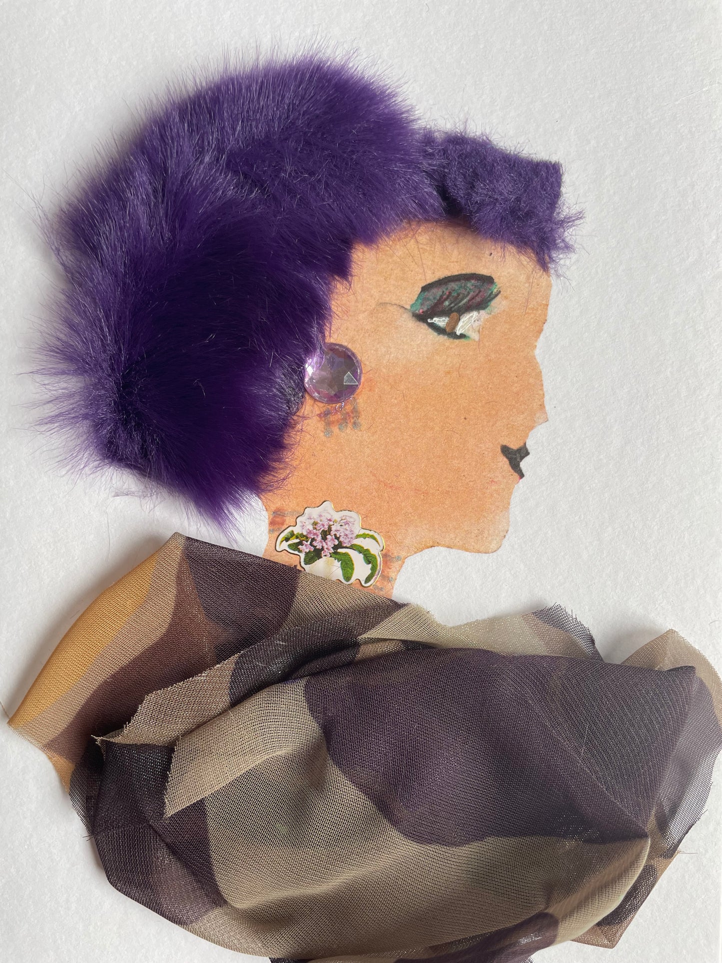 I designed this card of a woman named London Fields Lizzy. She has deep violet hair and wears a flowing brown blouse. She pairs it with a pinkish-white flower necklace and purple, jewelled earrings that match her hair.