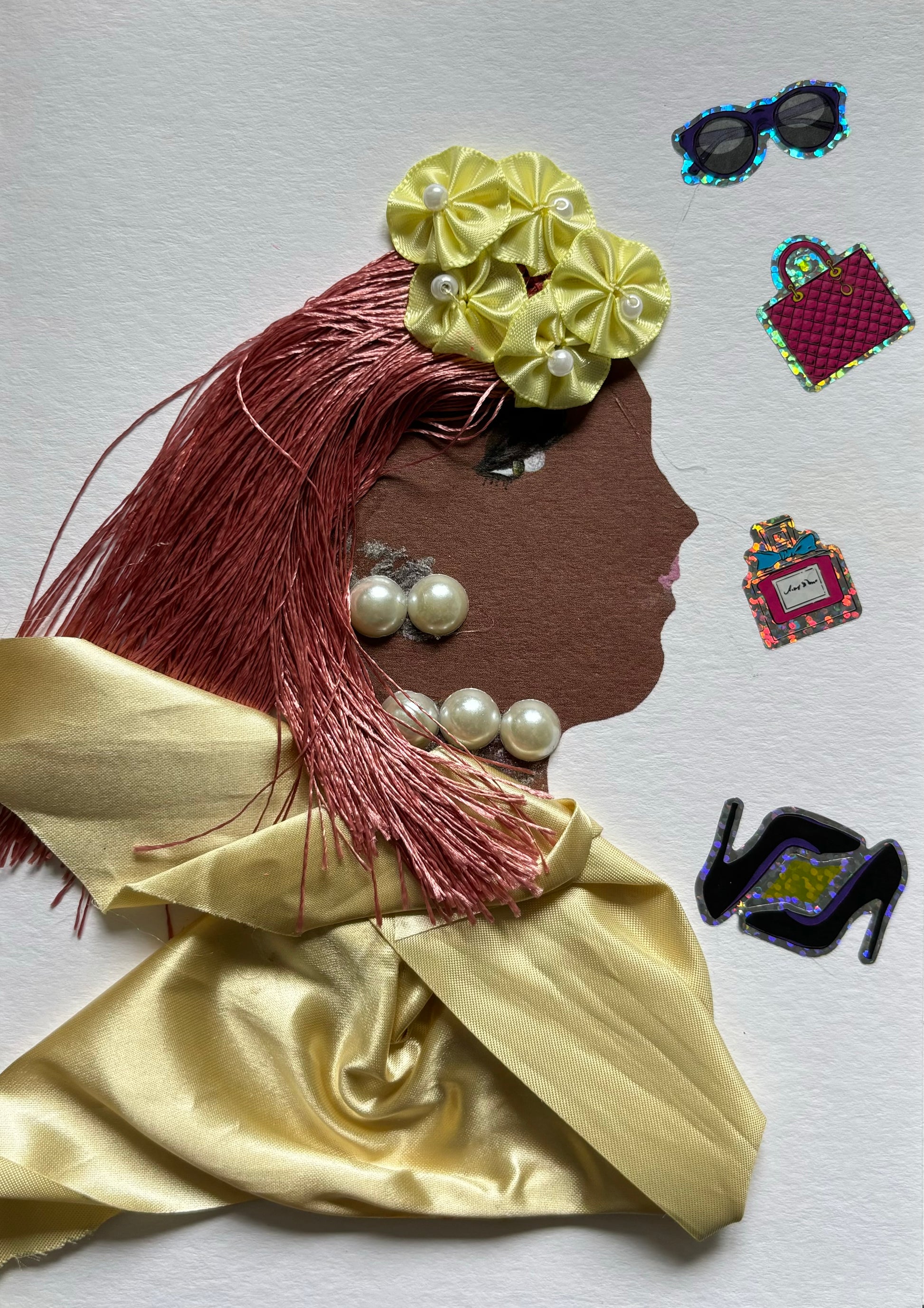 I designed this card for Westfield Pearl. She is a woman who is wearing a beautiful flowing golden blouse. Her blouse matches with her yellow flower headpiece. She has pink hair that contrasts nicely with the yellows of her outfit and she wears pearl jewellery to match with her name, Pearl.