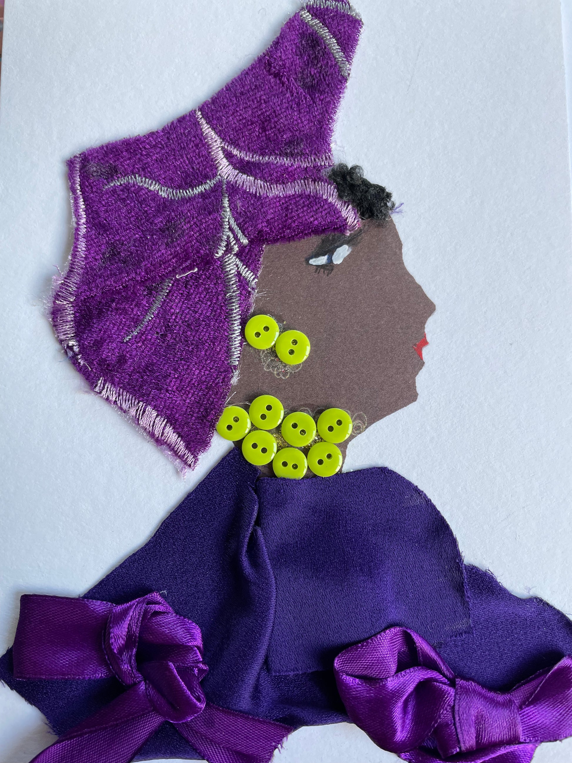 This is a card I have designed for a woman named Bella Indigo. She is wearing a lovely purple hat. She wears a tasteful violet blouse with charming silk purple bows. As a pop of color, she wears electric green button jewellery.