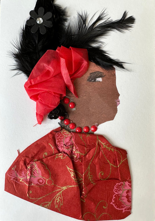 This card is designed for a woman named Greenwich Glenda. She is wearing a red blouse with a gold and pink flower pattern. Her hair is made of black feathers, and it is held together with red cloth and pinned with a black flower. Her outfit is completed with red gemstone jewellery.