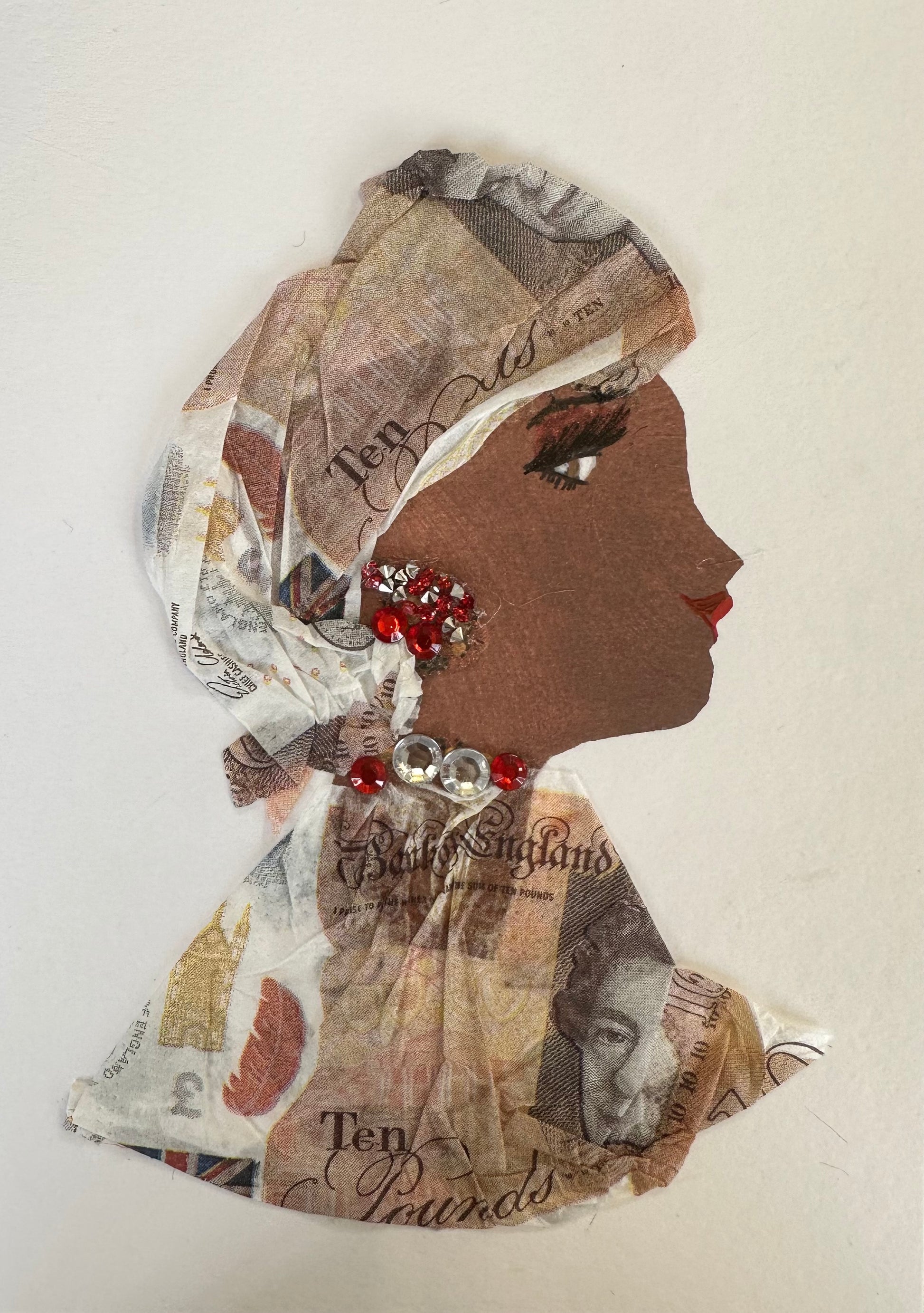 I designed this handmade card of a woman named Archway Andrea. She is dressed in a paper material hatinator and blouse that have ten pound pattern printed on it. The outfit is completed with silver and red gemstones for her jewellery.