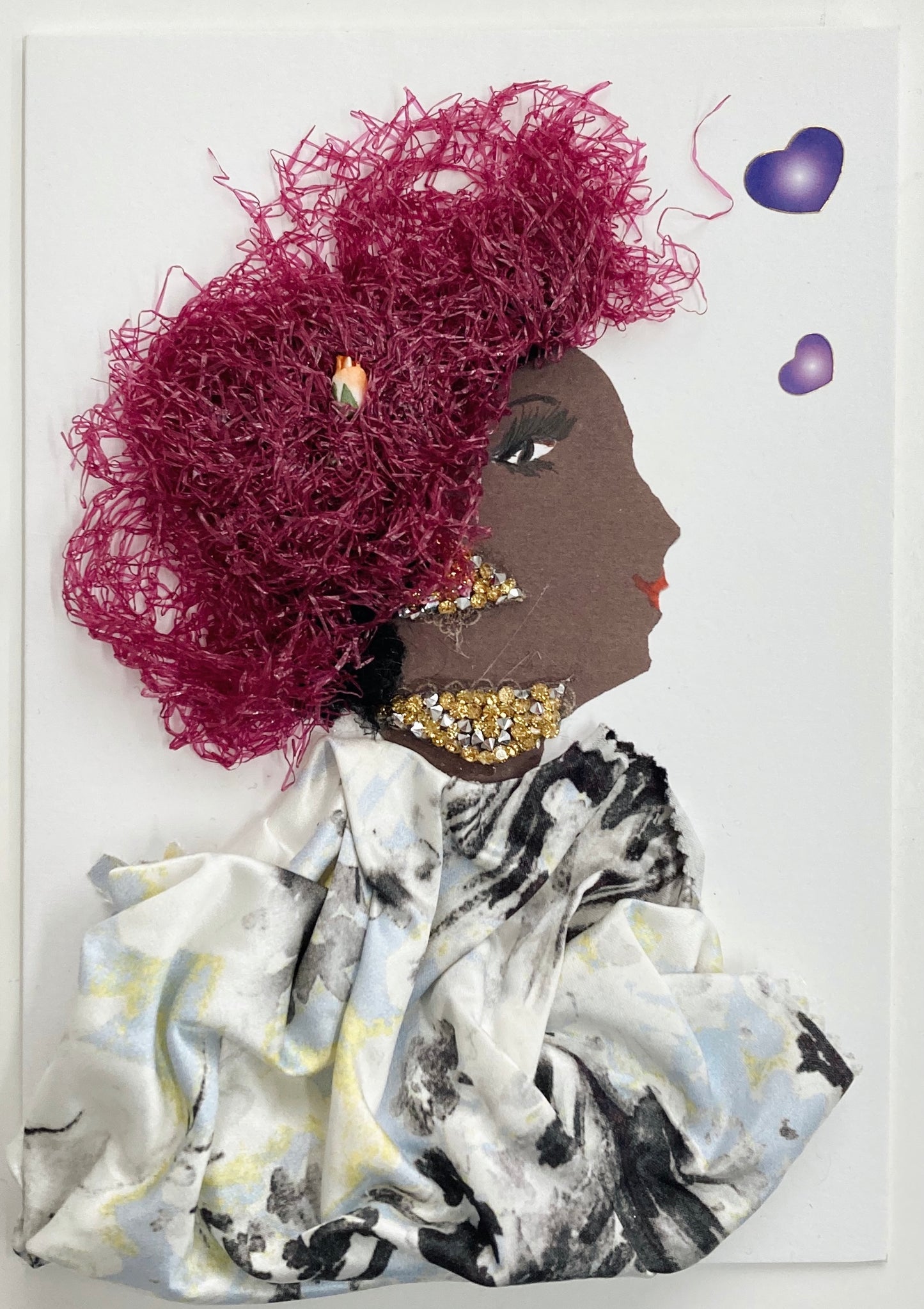 I designed this card for a woman named Fiona Finchley. She wears a black and white printed silk blouse, gold jewellery, and a purple textured headdress over her curly black hair. To her right, there are two purple hearts. 