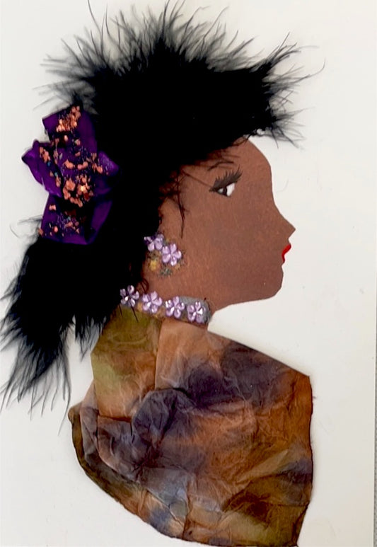 This card is of a woman wearing a multicoloured blouse. She has a purple sparkly bow in her long black feathery hair. She wears purple flower gems as jewellery. 